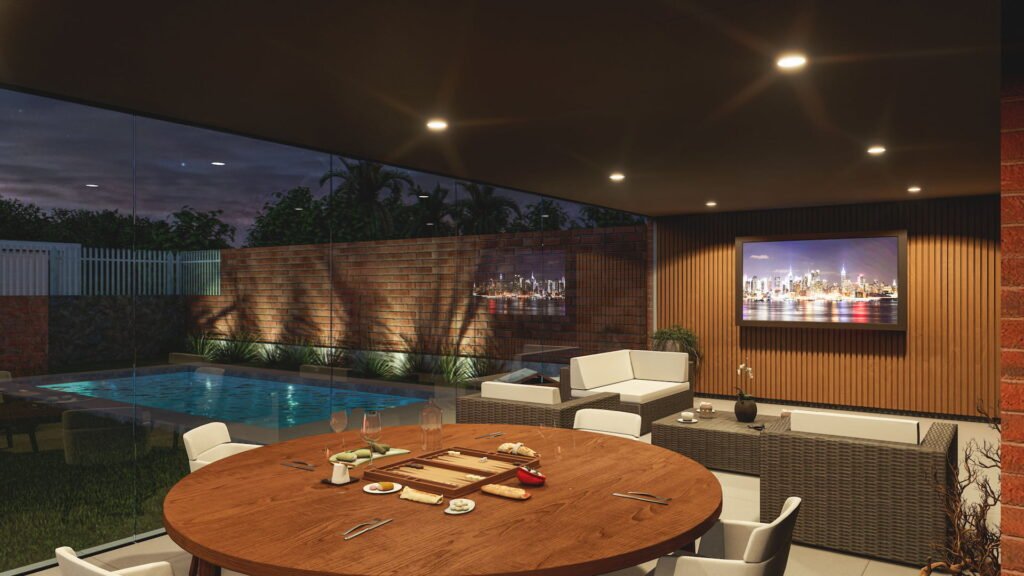 Vista nocturna desde comedor y estar a piscina y jardin con paisajismo e iluminación.