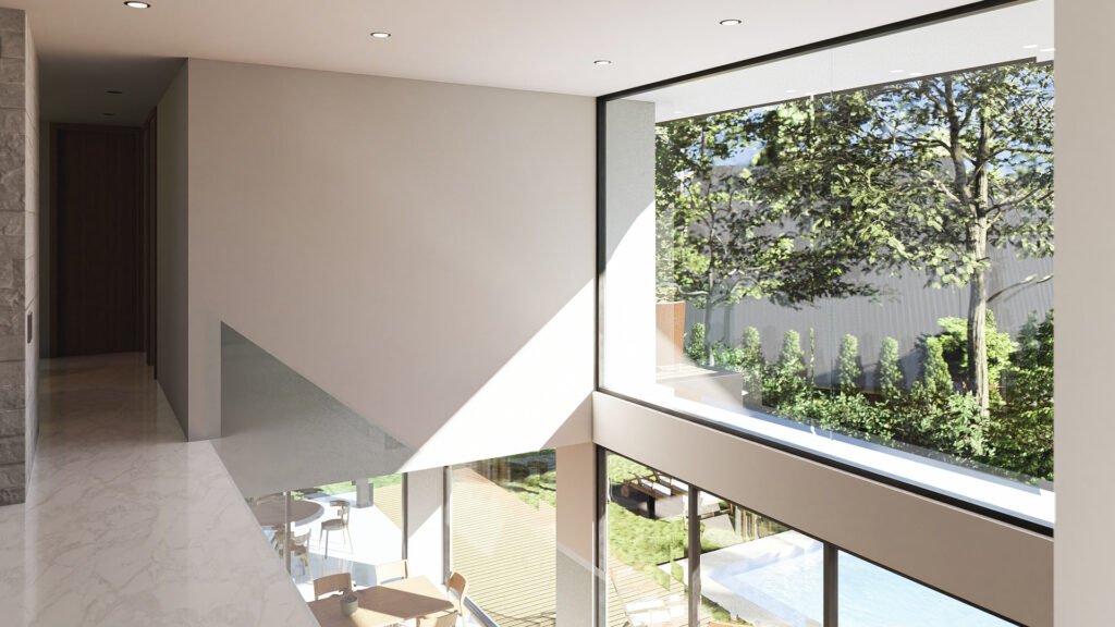 Vista circulación en segundo nivel en casa con gran ventanal a jardín.
